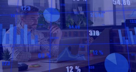 Caucasian businessman analyzing financial data on laptop in modern office