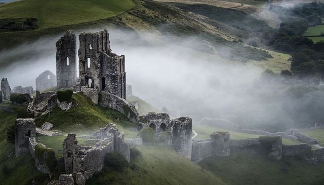 Drone approaching misty medieval castle ruins with animated overlays for travel storytelling