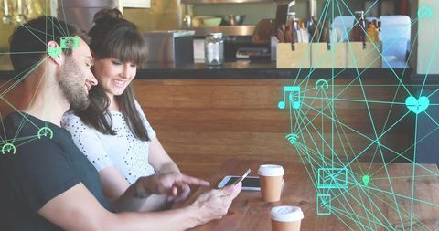 Young Couple Enjoying Coffee with Tech Icons Overlay