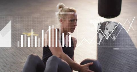 Female athlete performing seated russian twist with medicine ball in gym with data overlays