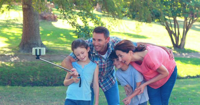 Enjoying Outdoor Family Time with a Selfie Stick in Park - Download Free Stock Images Pikwizard.com