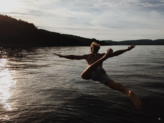 Man Leaping Into Lake at Sunset - Download Free Stock Images Pikwizard.com