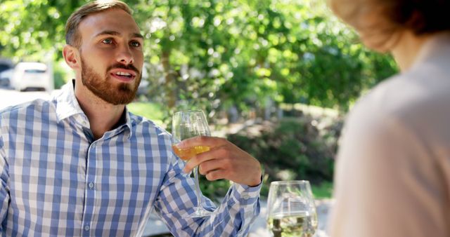 Man Enjoying Conversation Outdoors Holding Wine Glass - Download Free Stock Images Pikwizard.com