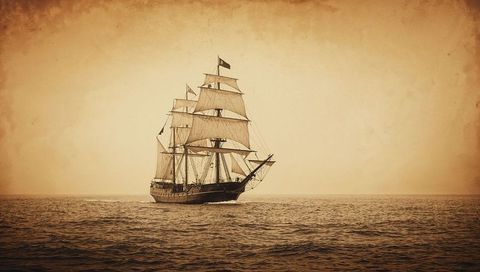 Vintage three-masted ship on open sea with sepia tones