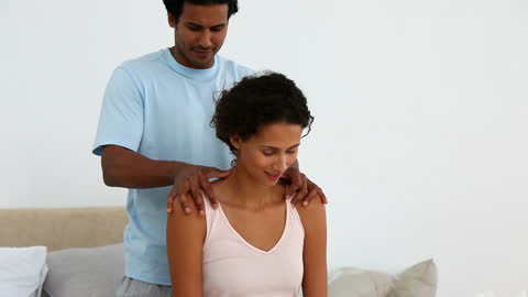 Man Performing Relaxing Shoulder Massage for Partner at Home