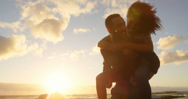 Happy Couple Piggybacking on Beach at Sunset - Download Free Stock Images Pikwizard.com