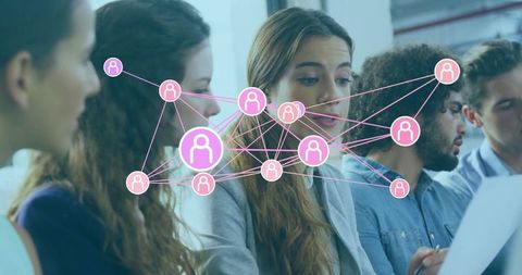 Young professionals collaborating with digital network graphics