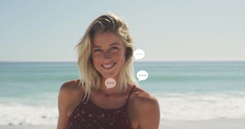 Smiling Woman in Floral Sundress Enjoying Sunny Beach Breeze