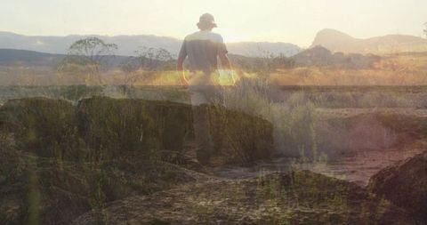 Hiker Ascending Desert Trail at Sunset with Intriguing Atmosphere