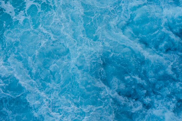Beautiful turbulent ocean waves creating vibrant turquoise textures. Ideal for backgrounds, design elements, nature presentations, marine-themed products, and graphics.