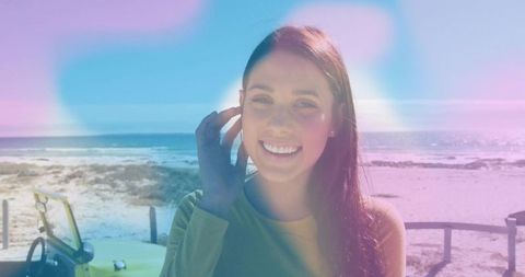 Cheerful Woman in Green Top on Idyllic Beach with Pastel Hues