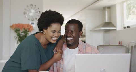 Happy African American Couple Using Laptop at Home