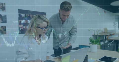 Finance Data Analysts Examining Market Trends in Modern Office