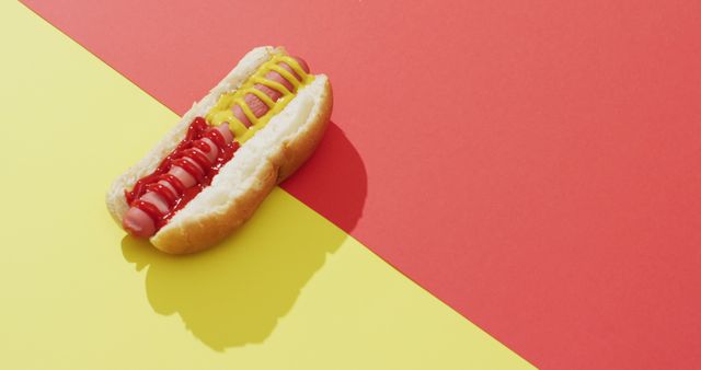 Image of hot dog with mustard and ketchup on a yellow and red surface. food, cuisine and catering ingredients.