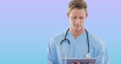 Caucasian Male Doctor Using Tablet with Blue Gradient Background - Download Free Stock Images Pikwizard.com