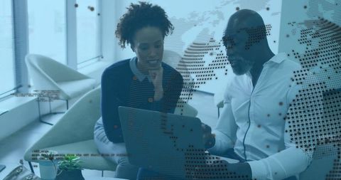 Collaborating professionals examining data in modern office