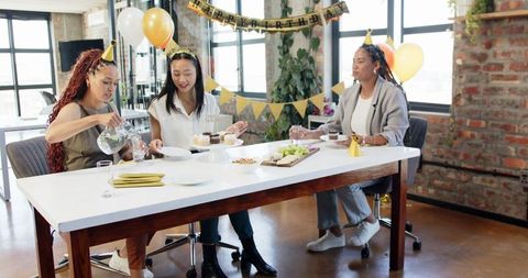 Office birthday celebration with diverse female colleagues