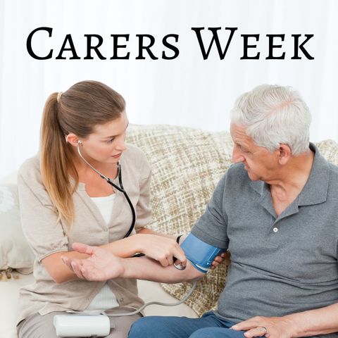 Healthcare worker measuring senior's blood pressure during carers week