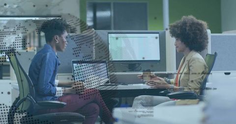 Professional Women Collaborate in Modern Workspace