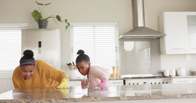Happy Biracial Mother and Daughter Cleaning Together in Modern Kitchen - Download Free Stock Images Pikwizard.com