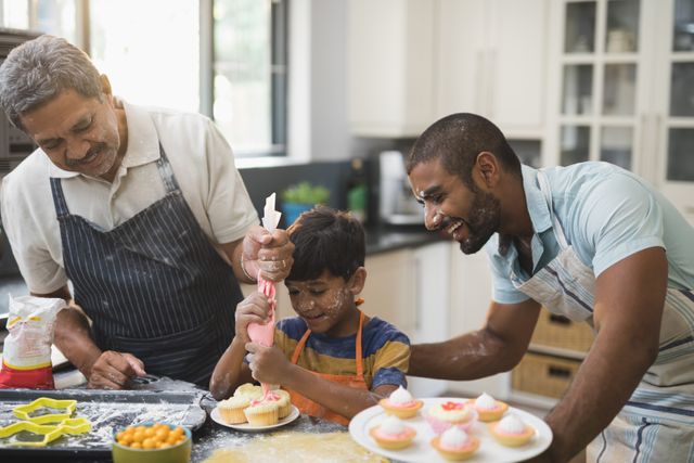 Happy multi-generation family preparing sweet food together in kitchen at home