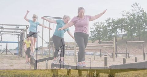 Women Balancing on Obstacle Course with Determination
