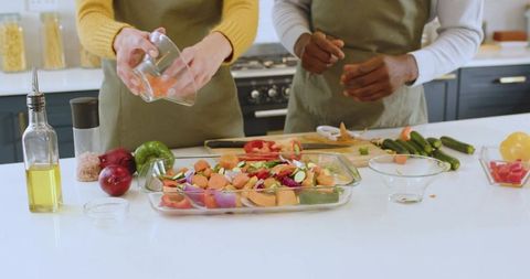 Friends Preparing Roasted Vegetables in Cozy Kitchen Atmosphere