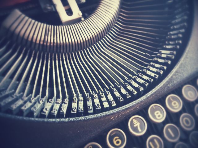 This photo provides a detailed view of a vintage typewriter, focusing on the intricately designed metal keys and numbers. Perfect for illustrating old-school communication and writing tools, it can be used in articles about the history of typewriters or in retro-themed designs. Additionally, it can complement stories about literature, authors, or the art of classic machinery.