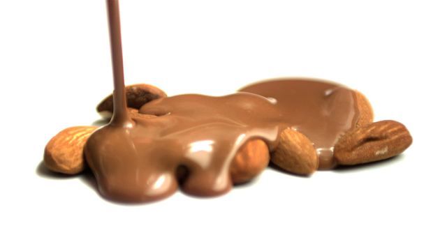 Chocolatiers, dessert bloggers, and food product marketers may find this inviting for their ads, blog posts, or recipe websites. Could also be used in promotions for nut mixes or gourmet chocolate brands to showcase the blend of flavors.