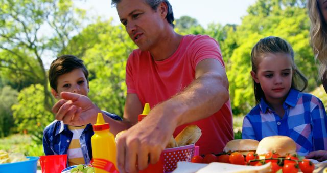 Father Enjoying Outdoor Picnic with Children on Sunny Day - Download Free Stock Images Pikwizard.com