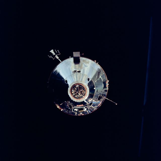 The Apollo 9 Command/Service Modules photographed from the Lunar Module,"Spider",on the fifth day of the Apollo 9 earth-orbital mission. Docking mechanism is visible in nose of the Command Module,"Gumdrop". Object jutting out from the Service Module aft bulkhead is the high-gain S-Band antenna. Film magazine was F, film type was SO-368 Ektachrome with 0.460 - 0.710 micrometers film / filter transmittance response and haze filter,80mm lens. 