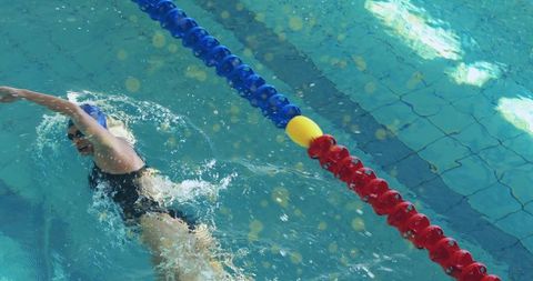 Professional swimmer in action performing front crawl stroke