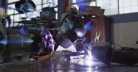 Woman Welder Welding Metal with Augmented Reality Data Overlays in Industrial Workshop