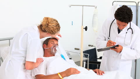 Medical Team Caring for Patient in Hospital Room Setting