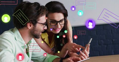 Collaborating over smartphone and tablet with colorful digital UI overlays in coworking
