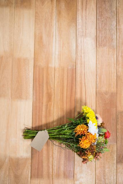Flower bouquet of different flowers on wooden board