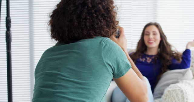 Photographer Capturing Smiling Woman with Long Hair Indoors - Download Free Stock Images Pikwizard.com