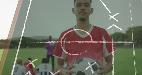 Young Soccer Player Holding Ball on Field for Training Session