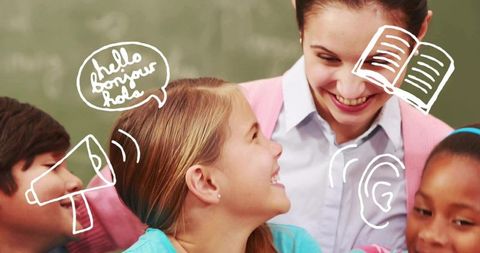 Smiling teacher guiding diverse children learning languages and collaborating in classroom
