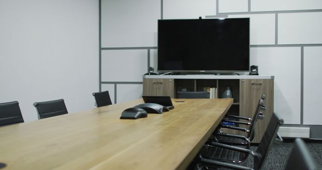 General view of empty conference room with television monitor, table and chairs in office. business and working in modern office.