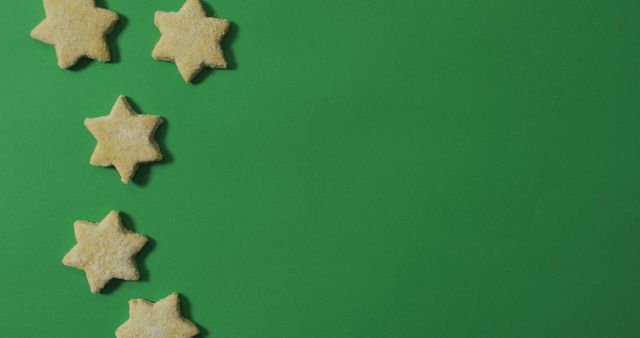 Star shaped christmas cookies and copy space on green background. christmas, tradition and celebration concept image.