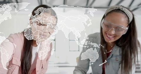 Students collaborating in stem lab wearing safety goggles with world map overlay