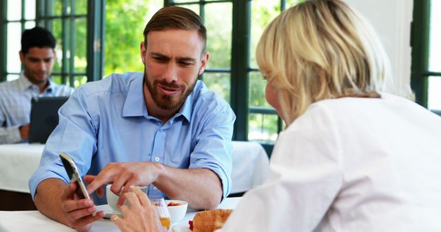 Business Partners Discussing Over Lunch in Modern Cafe - Download Free Stock Images Pikwizard.com