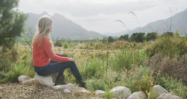 Woman Sitting Outdoors in Mountainous Landscape - Download Free Stock Images Pikwizard.com