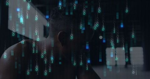 Bowing bare-shouldered man leaning over laptop in dim bedroom with falling binary code