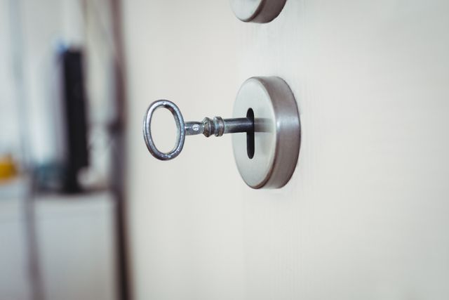 Close-up of key on door against blurred background
