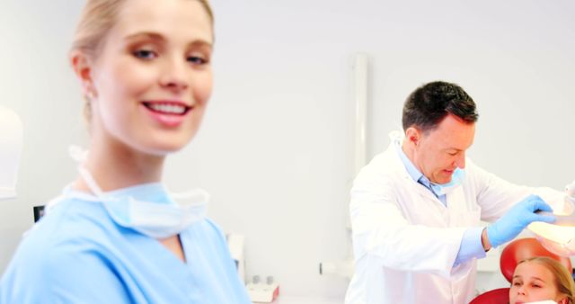 Young Female Dental Assistant and Dentist Treating Patient in Modern Clinic - Download Free Stock Images Pikwizard.com