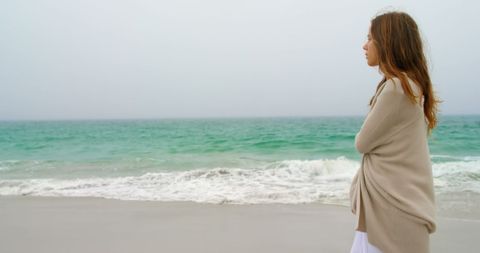 Pensive Woman Walking Along Sea Shore