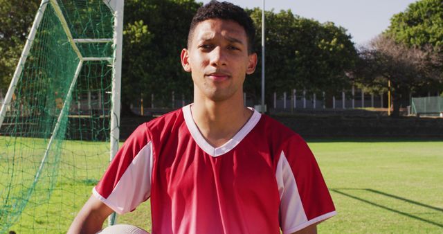 Young Soccer Player Posing on Field Holding Ball - Download Free Stock Images Pikwizard.com