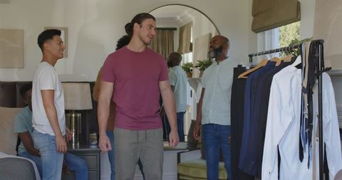 Friends Preparing for Wedding, Choosing Suit in Bedroom